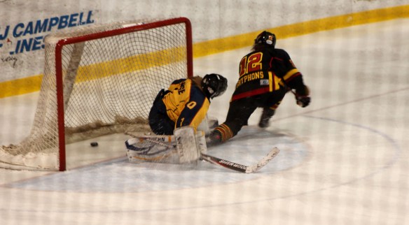 Guelph Gryphon Kaitlyn Mora #12,  scores on a breakaway making the score 3-0 against the Queen's Gaels. Gryphs went on to win the game 7-2 on Sat. Jan. 26, 2013. (Andrea Connell)