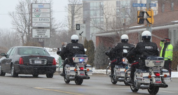 Motorcycle police accompany the funeral procession of Guelph Constable Jennifer Kovach on Thursday, March 21, 2013. Constable Kovach suffered fatal injuries in a crash on March 14, while responding to another officer's call for back-up. (Andrea Connell)